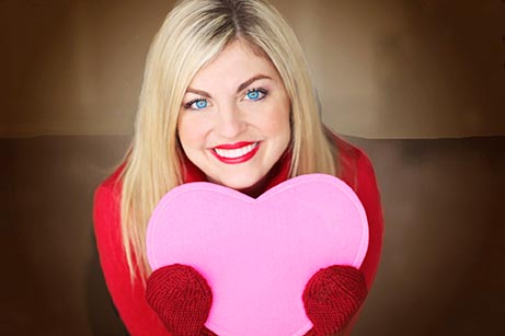 Women holding a valentines heart shaped box