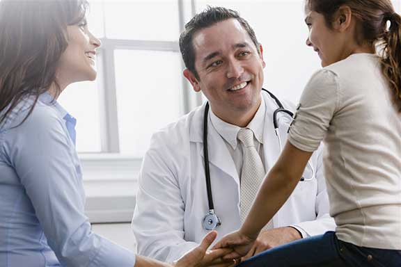 Mother and daughter talking to doctor